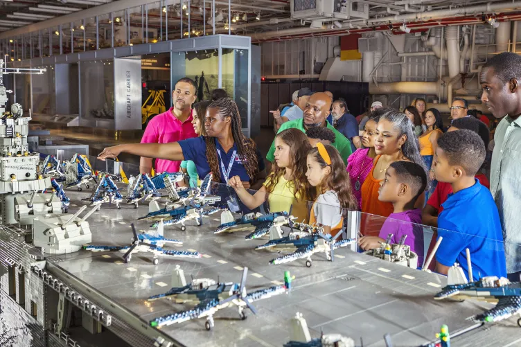 Kids and their families looking at model airplanes.