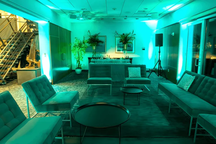 The VIP Room is set as a lounge with couches, a bar, and green uplighting 