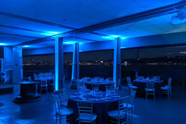 Seated dinner on the Fantail with blue event lighting