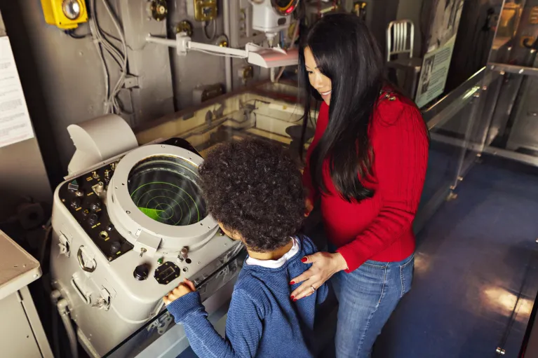 Boy and Mother exploring a radar station at the ship's Island