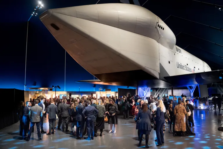 Guests gather for a cocktail reception in the Space Shuttle Pavilion