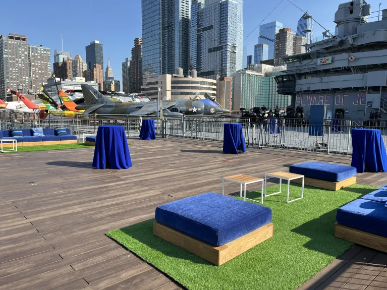 The port side aircraft elevator at flight deck level setup for a summer reception with lounge furniture