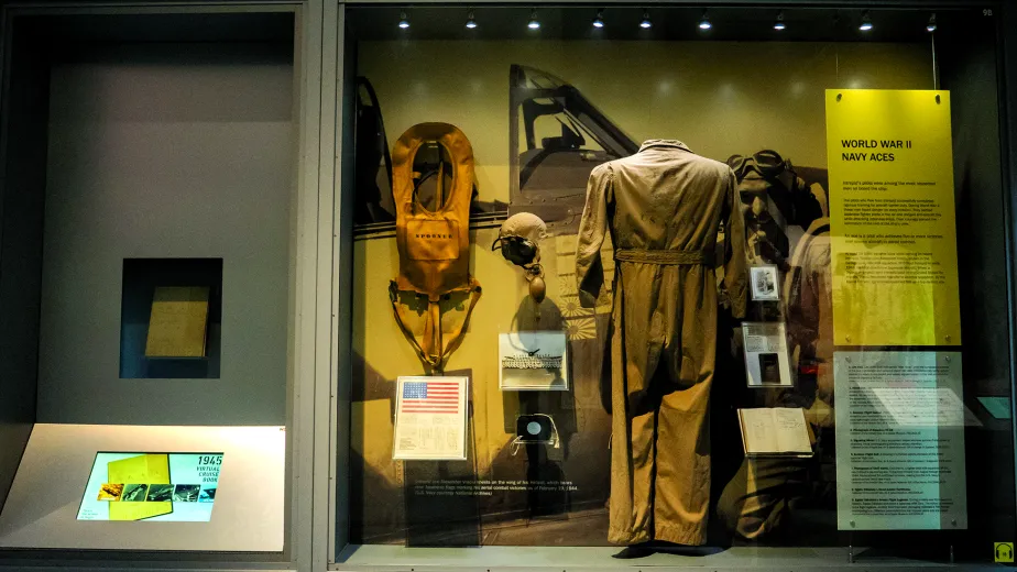 A display case featuring various artifacts, including a uniform
