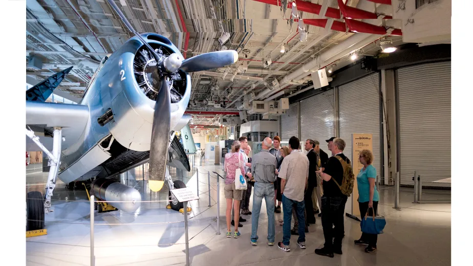 Group of visitors with a museum guide in front of the Avenger