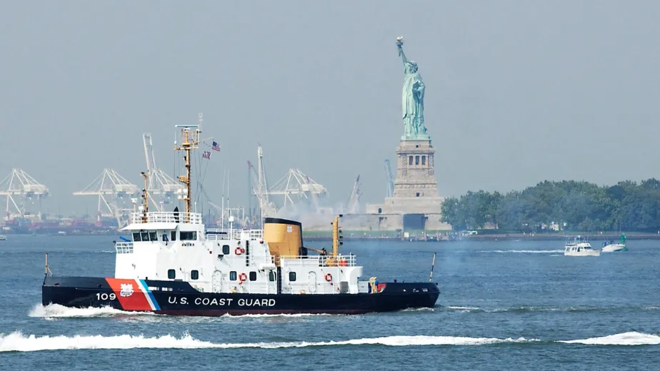 The USCGC Sturgeon Bay is seen in the Hudson River with the Statue of Liberty nearby.