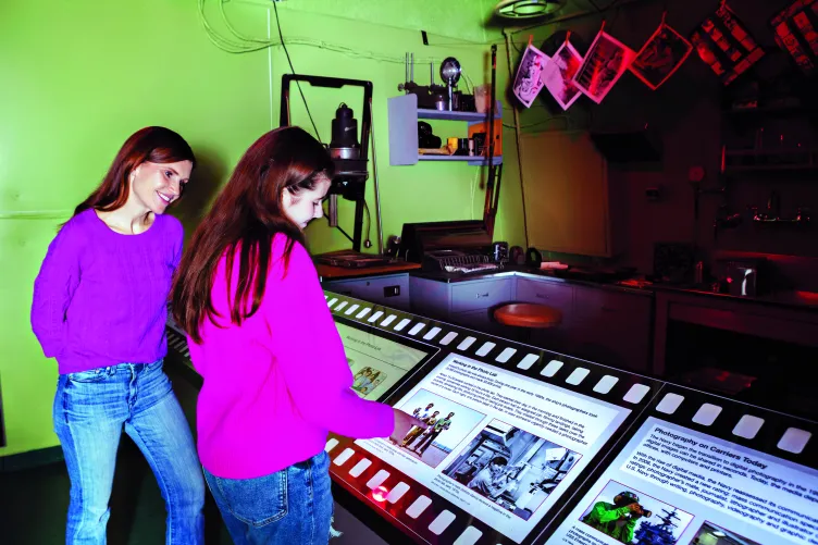 A mother and her teenage daughter explore the Museum's photo lab exhibition