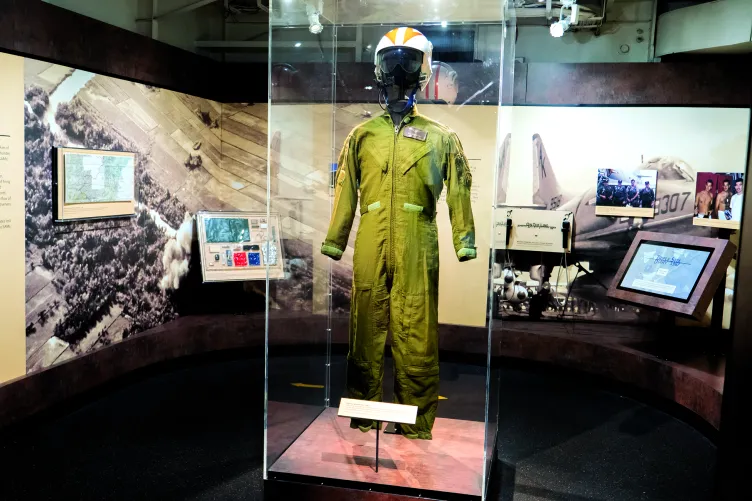 A display case featuring various artifacts, including a uniform