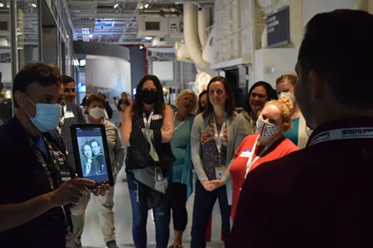 An educator teaching visitors at the USS intrepid museum about its' history