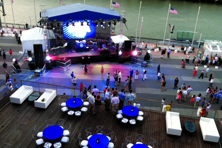 Aerial view of the pier with a stage and tables set up
