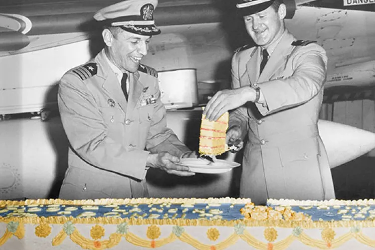 Some Navy men enjoying a cake onboard
