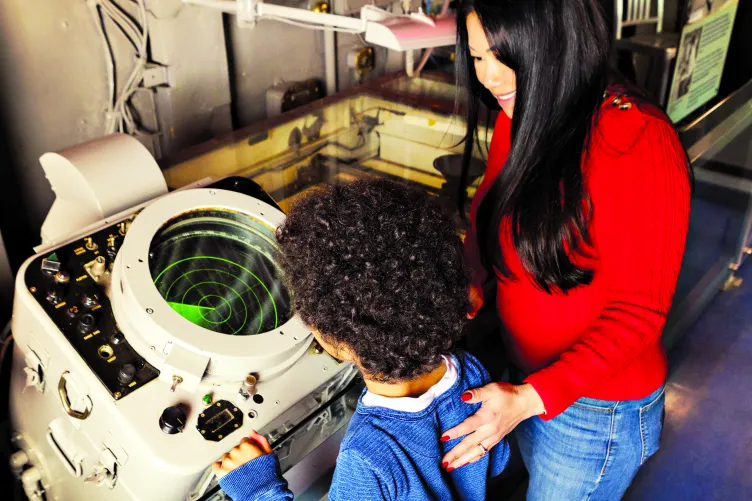 Mother and Kid looking at a Radar