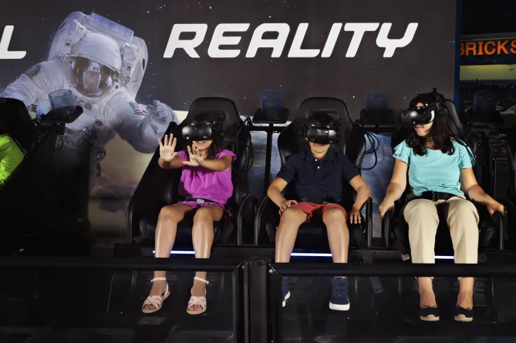 Kids enjoying a ride on the Apollo 11 & Beyond Virtual Reality Simulator