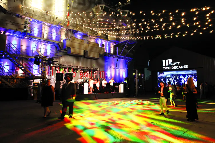 People dancing and listening to band play at an event at the Intrepid Flight Deck.