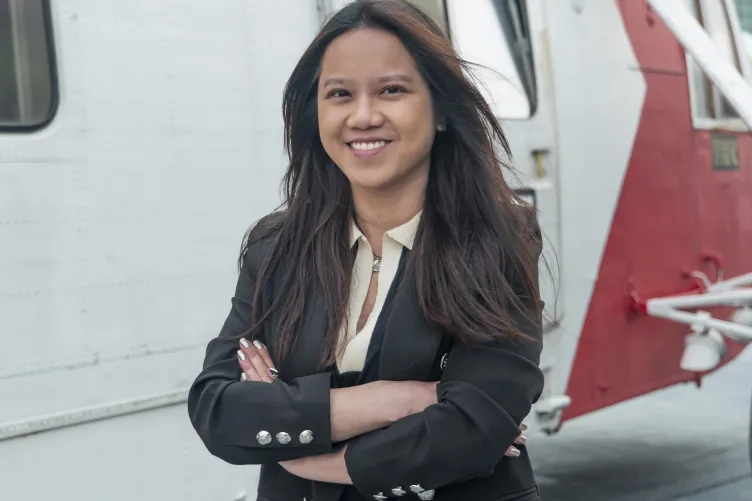 Headshot of Mi Dan Nguyen on the flight deck of Intrepid