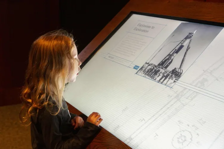 Young girl examining an exhibition display case