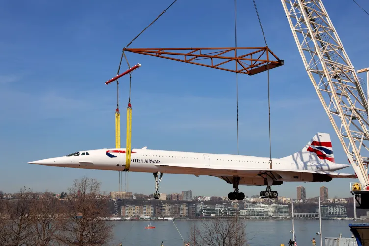 British Airways Concorde jet lifted up on a crane.