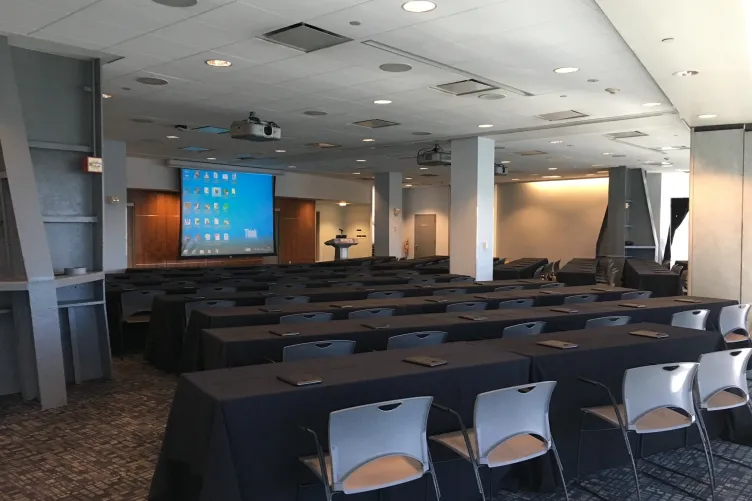 Classroom style seating facing the projector screen in the Great Hall for a conference