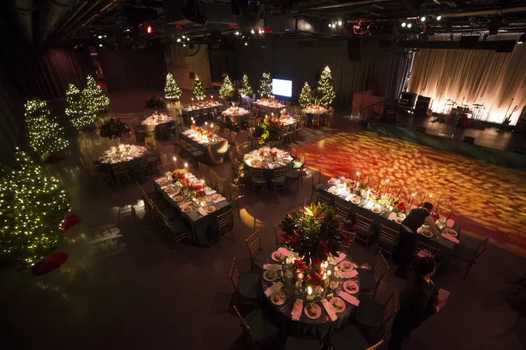 Hangar 3 set for a holiday party with a stage and room for dancing