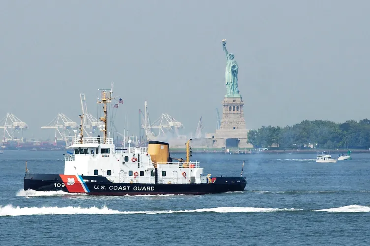 The USCGC Sturgeon Bay is seen in the Hudson River with the Statue of Liberty nearby.