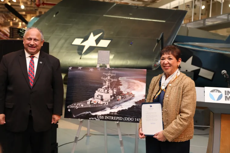 Mr. and Mrs. Del Toro stand together on the hangar deck of the Intrepid Museum.