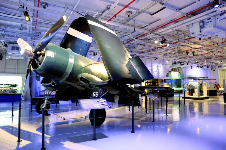 Corsair aircraft inside the Intrepid Museum's hangar deck in its permanent exhibition spot.