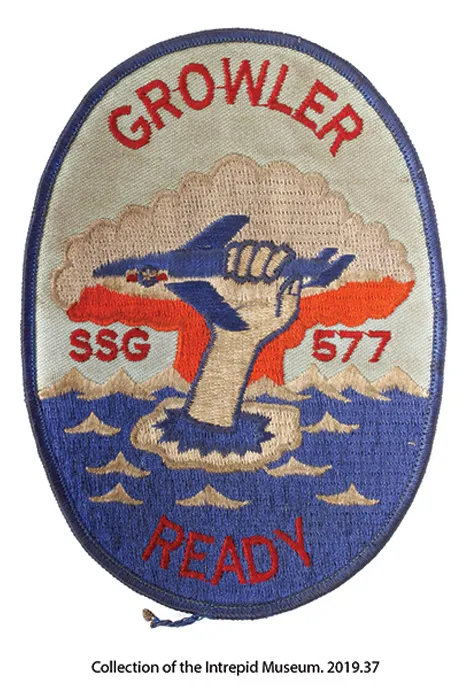 A patch that has a hand holding the Growler submarine.