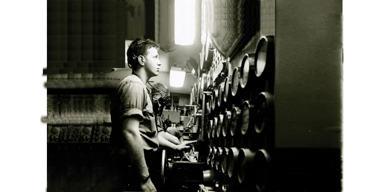 Sailor in the engine room of the aircraft carrier USS Intrepid fixes his gaze on the gauges in front of him.