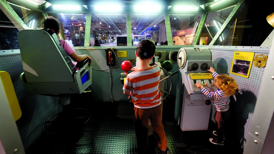 Three children playing in the Exploreum.