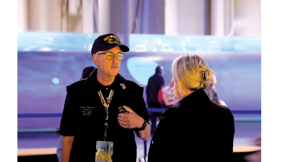 Museum volunteer interacting with a visitor