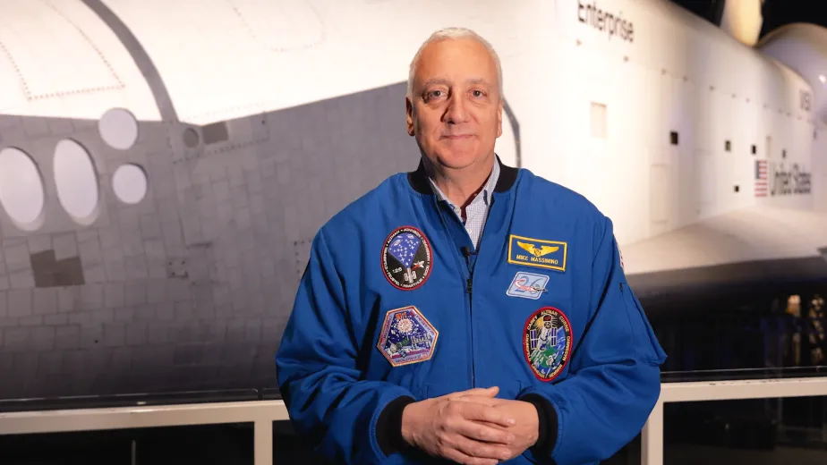 Mike Massimino, Senior Advisor of Space Programs at the Intrepid Museum, standing in front of the Space Shuttle.